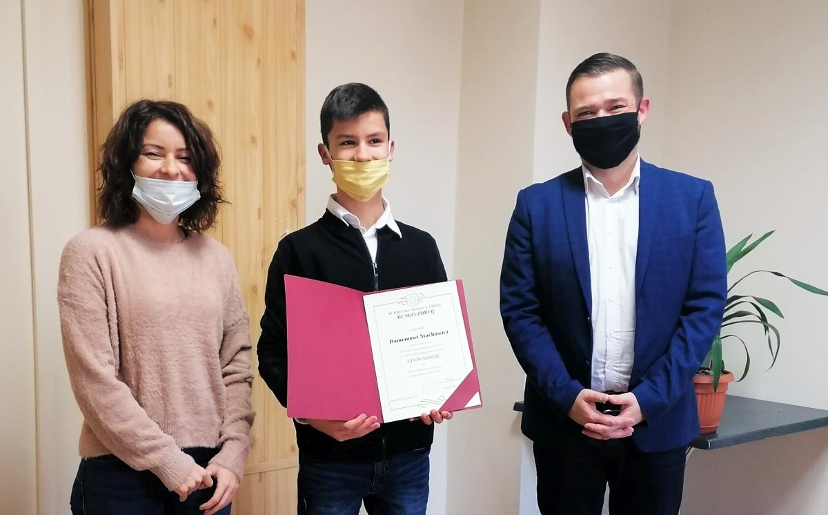 Zdjęcie przedstawia  Z-cę Burmistrza Miasta i Gminy Busku-Zdrój Michała Marońskiego, Stypendystę oraz jego mamę.