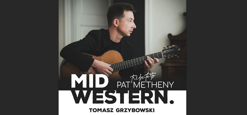 Muzyk Tomasz Grzybowski z gitarą