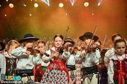 Młodzi skrzypkowie z zespołu Mała Armia Janosika w strojach ludowych na scenie BSCK