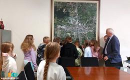 dzieci zwiedzają pomieszczenia w UMiG w Busku-Zdroju w towarzystwie burmistrza Waldemara Sikory